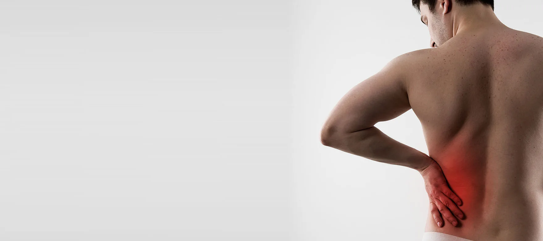 Original spinal decompression banner showing a person holding their lower back